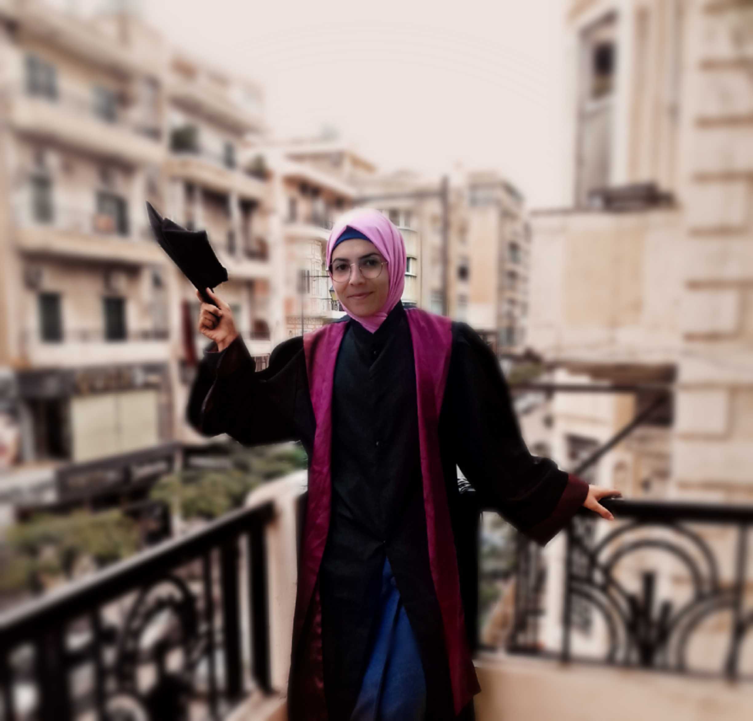 Syrian refugee and SNHU graduate Alnarjes on balcony