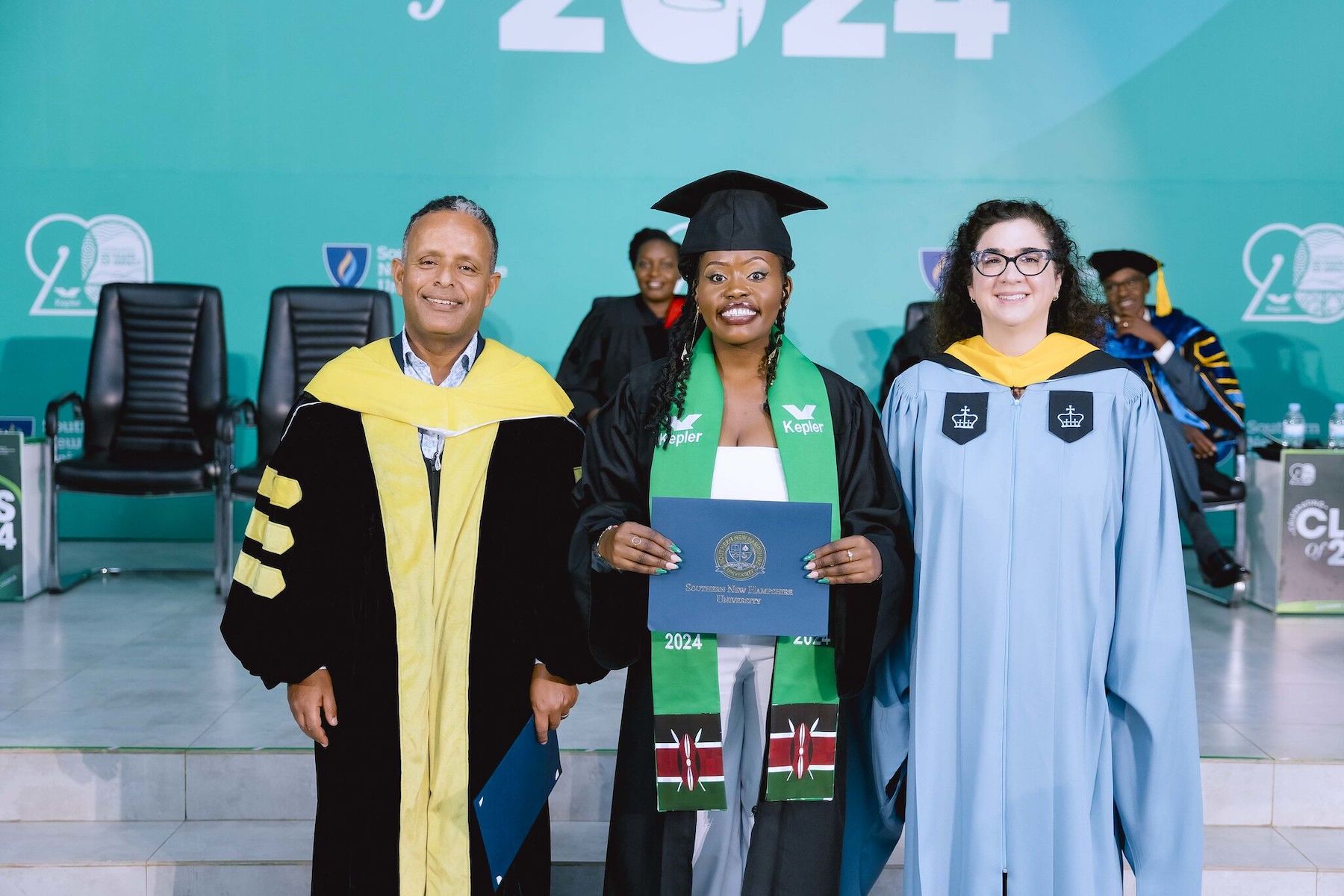 Graduate holding diploma