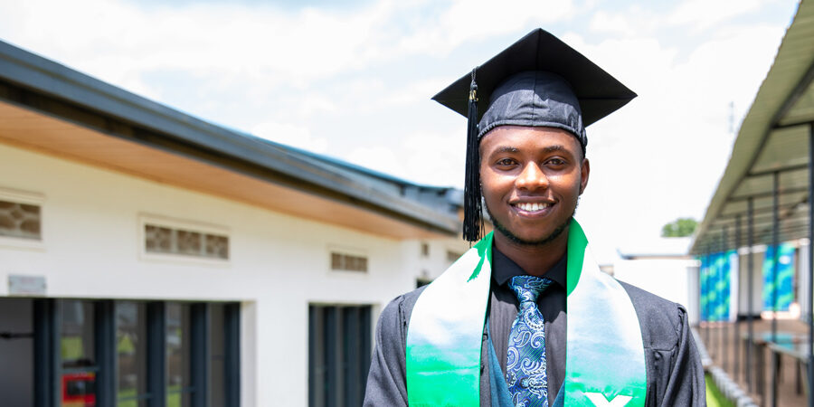 Mupenzi Niyomugabo wearing regalia and smiling